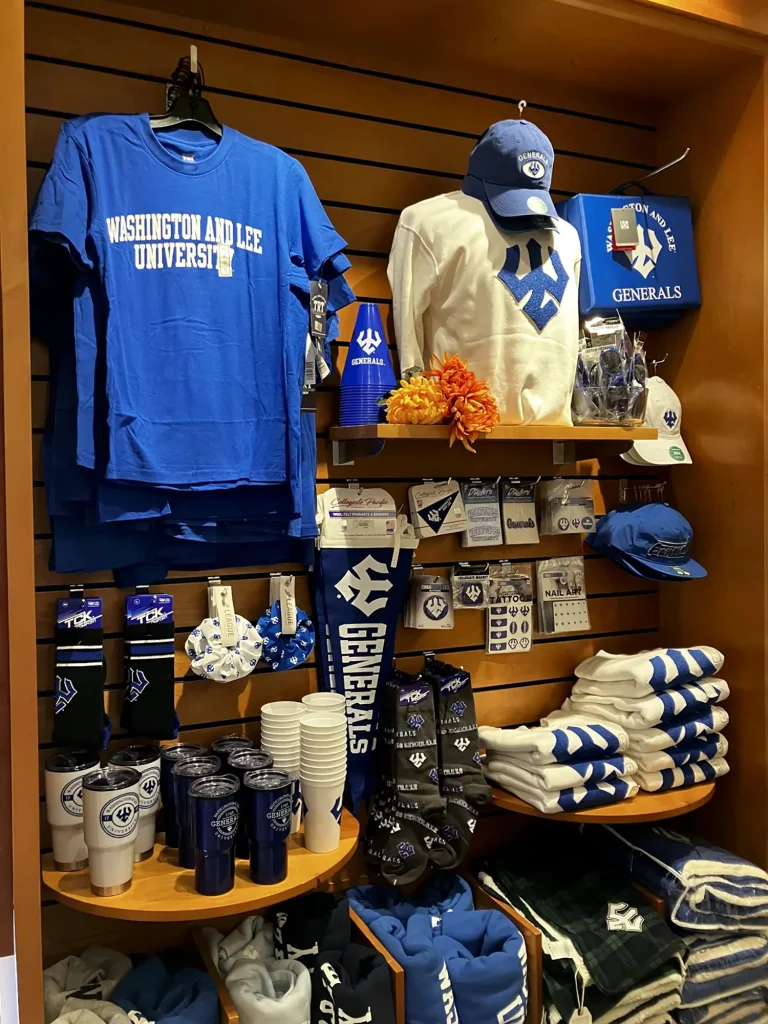 Custom printed merchandise display featuring branded apparel, drinkware, socks, hats, and promotional items